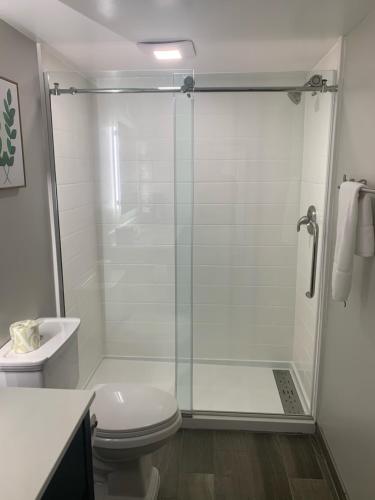 a bathroom with a shower with a toilet and a sink at Urban Boutique Hotel; BW Signature Collection in Greenville