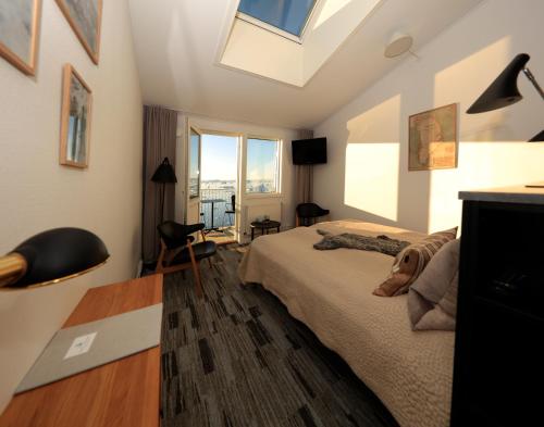 a bedroom with a bed and a skylight at Hotel Icefiord in Ilulissat
