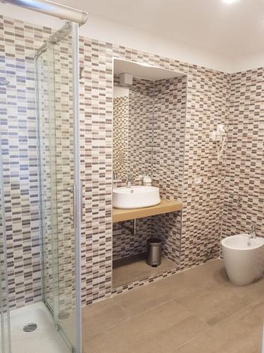 a bathroom with a sink and a shower at Savoy Riviera in Naples