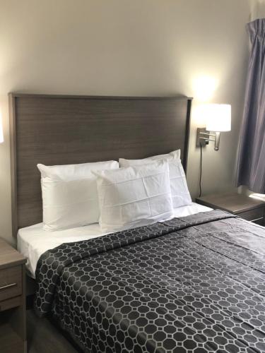 a bedroom with a large bed with white pillows at Trolley Stop Motel, Media ,Near PHL Airport PA in Media