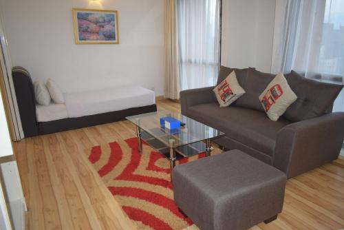 a living room with a couch and a coffee table at Grand Service Apartment @ Times Square in Kuala Lumpur