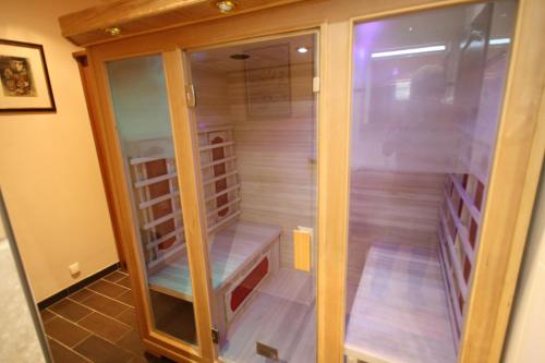 a walk in closet with glass doors in a room at Manoir de la Croix-Sonnet in Trouville-sur-Mer