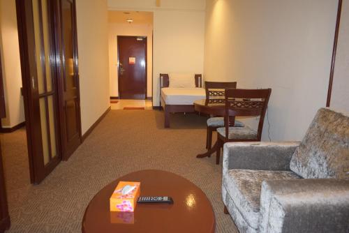 a living room with a couch and a table at Grand Service Apartment @ Times Square in Kuala Lumpur