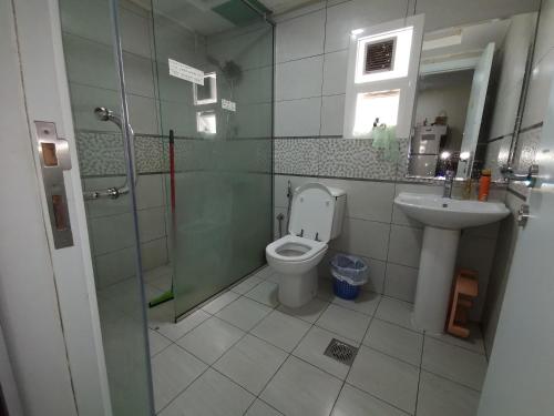 a bathroom with a toilet and a sink at Bed Space For Females Near Metro Station in Dubai