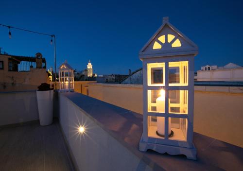 a lantern on the roof of a building at night at Blanco B&B - Group Puglia in Trani