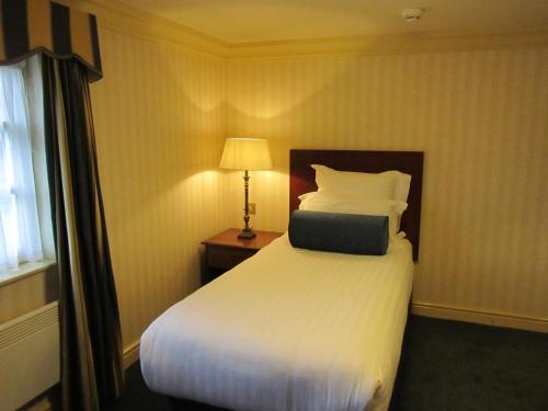 a hotel room with a bed with a laptop on it at Windmill Village Hotel, Golf Club & Spa, BW Signature Collection in Coventry