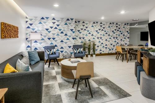 a living room with a couch and chairs and a table at Crowne Plaza Seattle Newly Renovated with No Resort Fee in Seattle