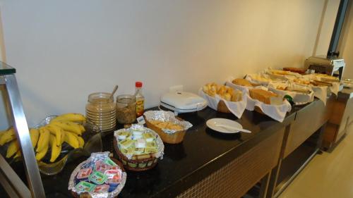 a counter with a bunch of food on it at Ilhabela Park Hotel in Brasilia