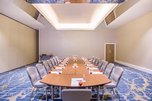 a large conference room with a long table and chairs at Crowne Plaza Gerrards Cross by IHG in Beaconsfield
