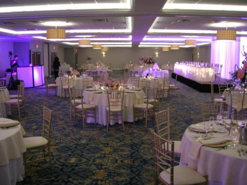 a room filled with tables and chairs with white table cloth at Crowne Plaza Hotel and Suites Pittsburgh South by IHG in Pittsburgh