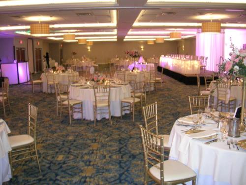 a banquet hall with white tables and chairs at Crowne Plaza Hotel and Suites Pittsburgh South by IHG in Pittsburgh
