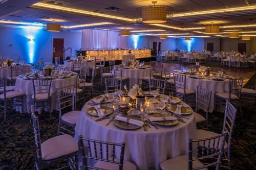 a banquet hall with white tables and chairs at Crowne Plaza Hotel and Suites Pittsburgh South by IHG in Pittsburgh