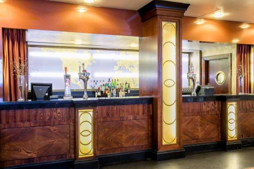 a bar in a restaurant with a mirror at Crowne Plaza Liverpool - John Lennon Airport by IHG in Liverpool