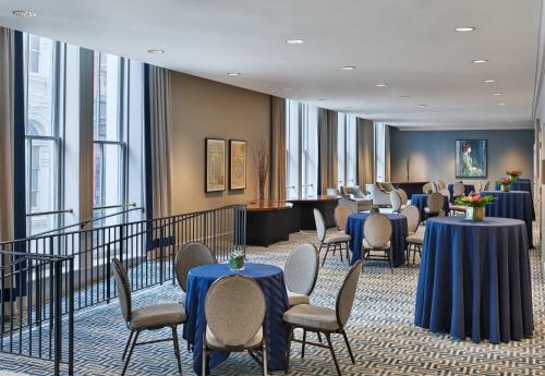 a waiting room with tables and chairs and windows at Crowne Plaza New Orleans French Qtr - Astor by IHG in New Orleans