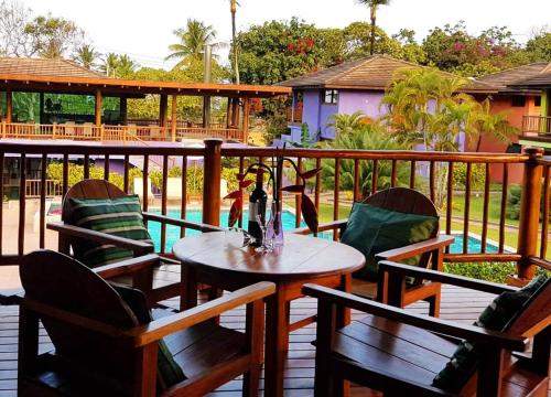 a patio with a table and chairs and a pool at BELLA VISTA Village in Arraial d'Ajuda