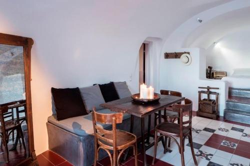 - un salon avec un canapé, une table et des chaises dans l'établissement Luxury Santorini Villa Secret Escape Villa Private Pool Sea Caldera View 2 BDR Oia, à Thólos