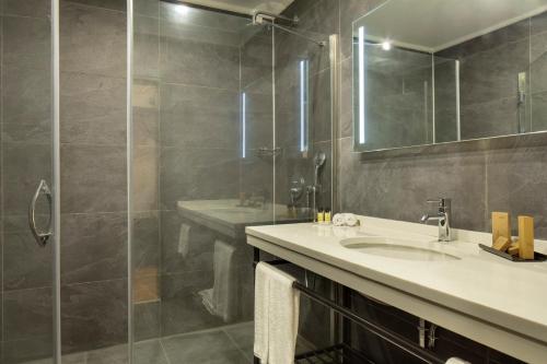 a bathroom with a sink and a shower at The Rooms Nisantasi in Istanbul