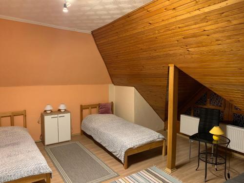 A bed or beds in a room at Bakonyi Mamutfenyő Vendégház