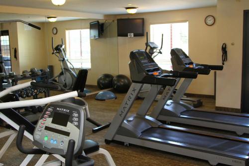 a gym with several treadmills and exercise bikes at Staybridge Suites Houston - Willowbrook by IHG in Houston
