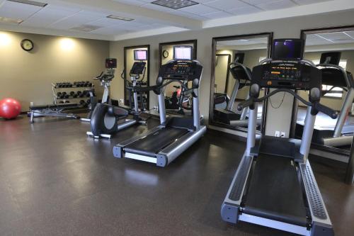a gym with several tread machines in a room at Staybridge Suites Silicon Valley - Milpitas by IHG in Milpitas