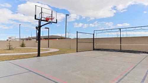 a basketball hoop with a basket on a court at Staybridge Suites - Calgary Airport by IHG in Calgary