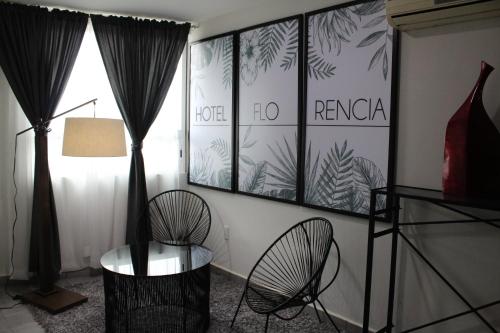 a room with a table and a chair and a window at Hotel Florencia Poza Rica in Poza Rica de Hidalgo