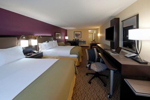 a hotel room with two beds and a desk with a computer at Holiday Inn Express Hotel & Suites Clearfield by IHG in Clearfield