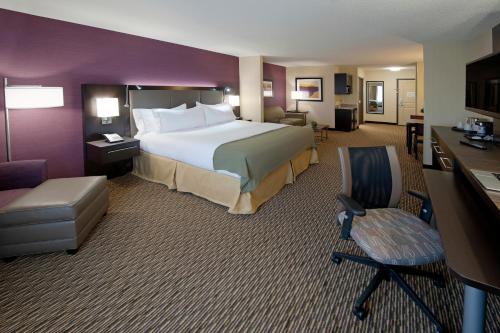 a hotel room with a large bed and a desk at Holiday Inn Express Hotel & Suites Clearfield by IHG in Clearfield