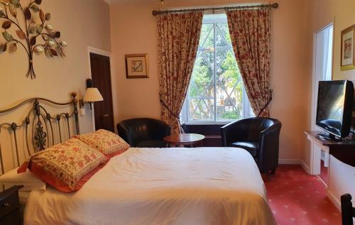 Кровать или кровати в номере Stow Lodge Hotel