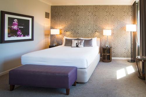 a hotel room with a bed and two lamps at Hotel De Anza, a Destination by Hyatt Hotel in San Jose