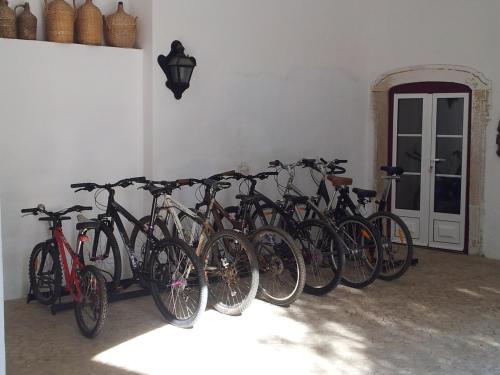 a bunch of bikes lined up against a wall at Casa da Tia Guida in Golegã