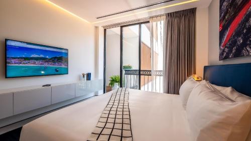 a living room with a large tv on a wall at PIER 57 - 410 Amazing 2 BR Condo Romantic Zone in Puerto Vallarta