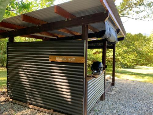 a large metal garage with a roof on top of it at Noah Creek Eco Huts in Cape Tribulation