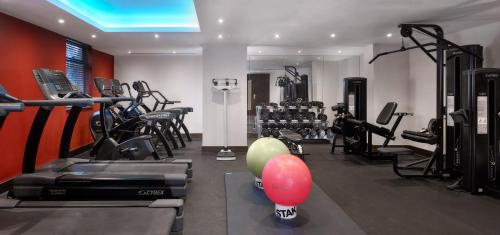 a gym with treadmills and exercise equipment in a room at Crowne Plaza London - Gatwick Airport by IHG in Crawley