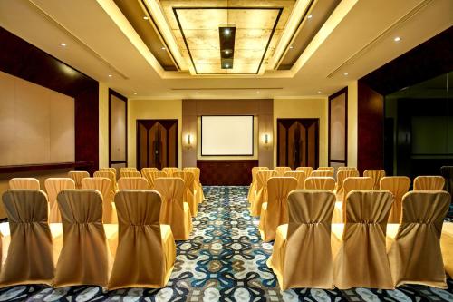 a conference room with rows of chairs and a screen at Crowne Plaza Tianjin Binhai by IHG in Tianjin