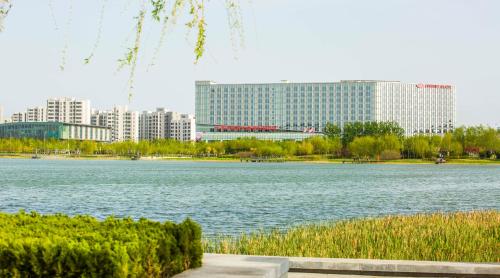a large body of water with a building in the background at Crowne Plaza Tianjin Binhai by IHG in Tianjin