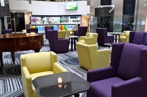 a lobby with chairs and tables and a bar at Crowne Plaza Hotel Mexico City North-Tlalnepantla by IHG in Mexico City