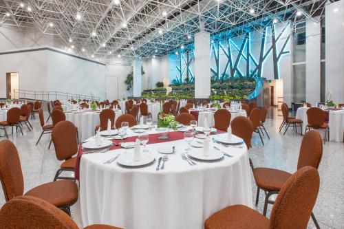 a banquet hall with white tables and chairs at Crowne Plaza Hotel Mexico City North-Tlalnepantla by IHG in Mexico City