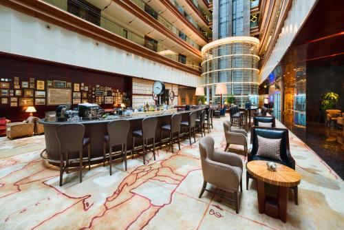 a hotel lobby with a bar and chairs at Crowne Plaza Suzhou by IHG in Suzhou