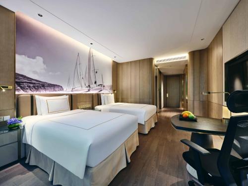 a hotel room with two beds and a desk at Crowne Plaza Suzhou by IHG in Suzhou