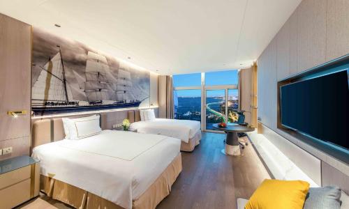 a hotel room with two beds and a flat screen tv at Crowne Plaza Suzhou by IHG in Suzhou