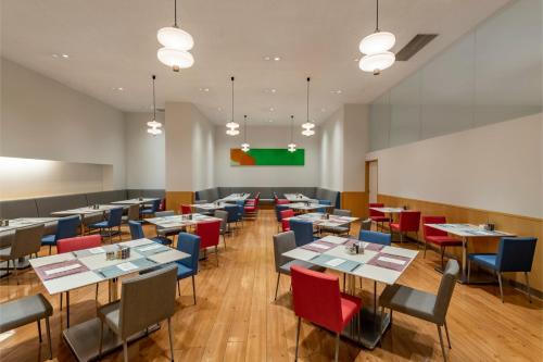 a dining room with tables and chairs and a greenboard at ANA Crowne Plaza Kobe by IHG in Kobe