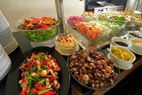 a buffet filled with bowls of different types of food at Crowne Plaza Monterrey Aeropuerto by IHG in Monterrey