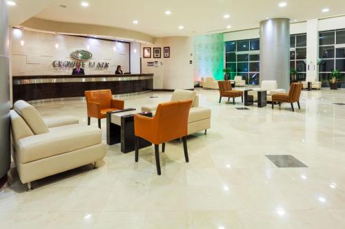 a lobby with chairs and tables in a mall at Crowne Plaza Leon by IHG in León