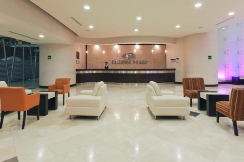a waiting room with chairs and a counter at Crowne Plaza Leon by IHG in León