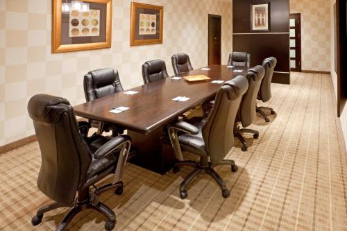 a conference room with a wooden table and chairs at Staybridge Suites DFW Airport North by IHG in Irving