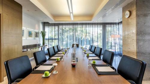a long conference room with a long table and chairs at Crowne Plaza Limassol by IHG in Limassol