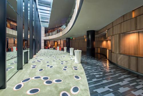 a hallway with a carpet in a building at Crowne Plaza Changi Airport by IHG in Singapore