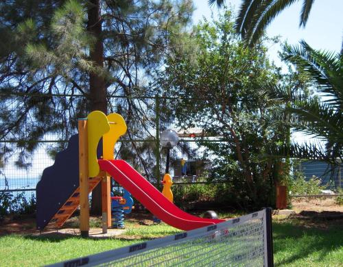 a playground with a slide in a park at Crowne Plaza Limassol, an IHG Hotel in Limassol