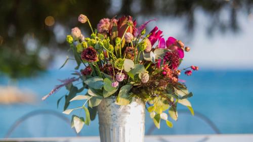 a white vase filled with a bouquet of flowers at Crowne Plaza Limassol by IHG in Limassol